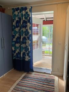 an open door with a curtain in a room at Charming, quiet apartment in Kvissleby