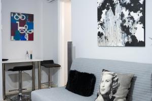 a bedroom with a bed and a table with a desk at Amarysia Residence in Athens