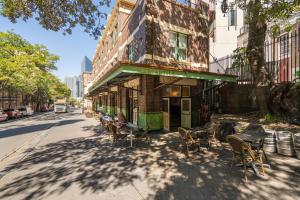 a building with tables and chairs on a street at Mercantile Hotel in Sydney