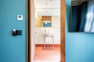 a bathroom with a sink and a white sink at Mercantile Hotel in Sydney