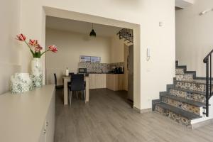 a kitchen and dining room with a table and stairs at La Dimora Aragonese in Randazzo