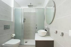 a bathroom with a toilet and a sink and a mirror at La Dimora Aragonese in Randazzo +22 photos