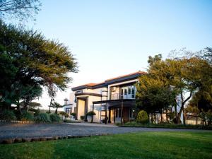 a large house with a yard in front of it at Meloding Guest House in Bela-Bela
