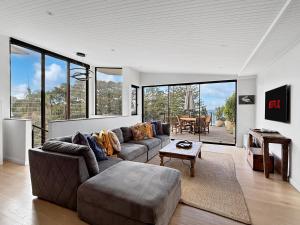 a living room with a couch and a table at BRON455B - Bronte Beach House with Ocean Views in Sydney
