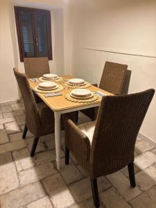 a dining room table with chairs and plates on it at Casa Il Borgo in Tavernelle