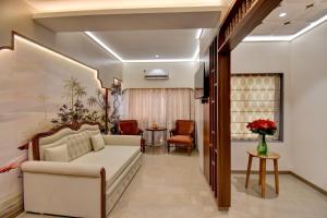 a living room with a couch and a table at Hotel Bhagyalaxmi in Shirdi