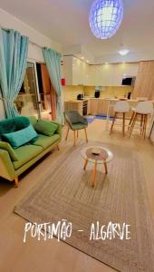 a living room with a green couch and a table at GM Premium Portimão in Portimão +88 photos