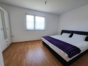 a bedroom with a bed and a window at Family Nature Escape in Malešići
