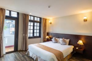 a hotel room with a large bed and a window at Lacasa Sapa Hotel in Sapa +41 photos