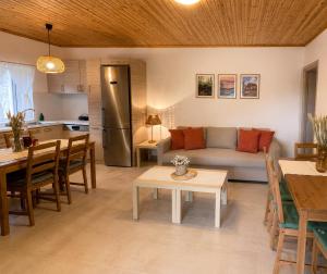 a living room and kitchen with a couch and a table at Taygetos hut in Dhirrákhion