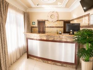 a hotel lobby with a reception desk and a tv at Azania Bed & Breakfast in Meyerton +5 photos