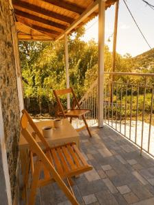 a patio with a table and chairs on a porch at Taygetos hut in Dhirrákhion
