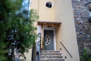 a door of a house with stairs leading to it at Casa Maria-Anneta in Kalives Poligirou