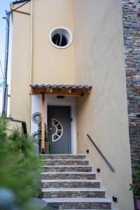 a building with stairs leading up to a door at Casa Maria-Anneta in Kalives Poligirou
