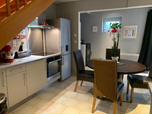 a kitchen with a table and a dining room at La Maison Clémenso in Cluny +11 photos