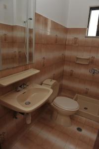 a bathroom with a toilet and a sink at Steve's Beach in Faliraki
