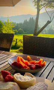 a plate of fruit on a wooden table at Chalet - Kleines Paradies - in Appenzell