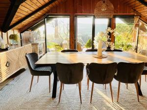 a dining room with a wooden table and chairs at Chalet - Kleines Paradies - in Appenzell