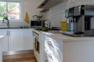 a kitchen with white cabinets and a counter top at Magnolia Cottage in Cape Town