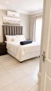 a bedroom with a large white bed in a room at Azania Bed & Breakfast in Meyerton