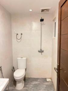 a bathroom with a toilet and a shower at Sky residences in Lahore