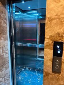 a glass elevator with a sign in front of it at Sky residences in Lahore