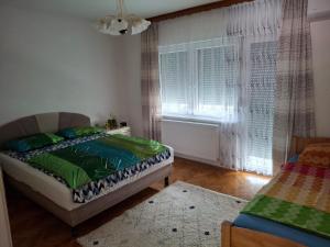 a bedroom with a bed and a window at Jasmir in Bihać