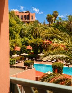 a view of a pool from a balcony of a resort at Kennedy Hospitality Resort in Marrakesh