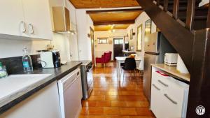 a kitchen with a counter and a dining room at Gîte de L'Abbaye in Nolay