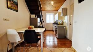 a kitchen with a table and chairs in a room at Gîte de L'Abbaye in Nolay