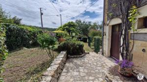 a house with a garden next to a building at Gîte de L'Abbaye in Nolay
