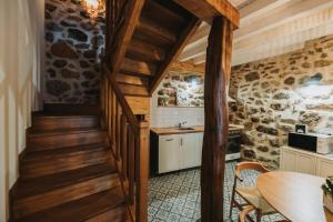 a staircase leading up to a kitchen in a house at La casa del Mayoral in Tremedal