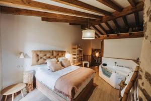 a bedroom with a bed and a tub and a sink at La casa del Mayoral in Tremedal