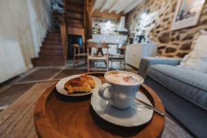 a cup of coffee and a pastry on a coffee table at La casa del Mayoral in Tremedal +36 photos
