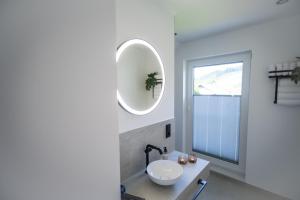 a bathroom with a sink and a mirror on the wall at Eickhagen Nº7 - 10 Personen - 5 Schlafzimmer - 220qm - 4 Badezimmer - Wellness - Sauna in Olsberg +48 photos