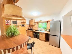 a kitchen with a stainless steel refrigerator and a table at Eden in Sędziszowa