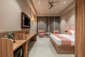 a hotel room with a bed and a television at Hotel Highway King Dhodsar in Gūdha