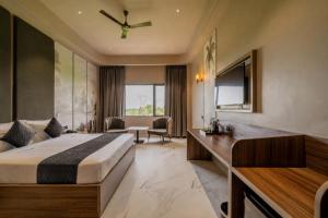 a hotel room with a bed and a desk at Hotel Highway King Dhodsar in Gūdha