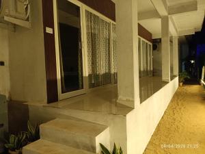 a porch of a house with a window at Avish Dubbansasi Beach stay Resort Gokarna in Gokarn