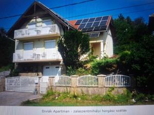 a house with solar panels on the roof at Diviák Apartman in Zalaszentmihály