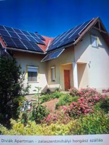 a house with solar panels on the roof at Diviák Apartman in Zalaszentmihály
