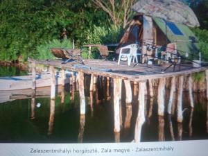 a picture of a dock with a rv on the water at Diviák Apartman in Zalaszentmihály +1 photo