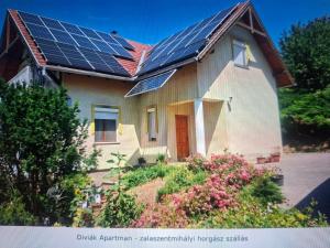 a house with solar panels on the roof at Diviák Apartman in Zalaszentmihály