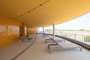 a building with benches and tables on a balcony at Canvas Valencia Burjassot in Burjassot