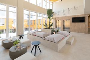 a bedroom with two beds and a tv in a room at Canvas Valencia Burjassot in Burjassot