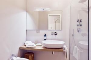 a white bathroom with a sink and a shower at La Dimora Guest House in Castel di Sangro +36 photos
