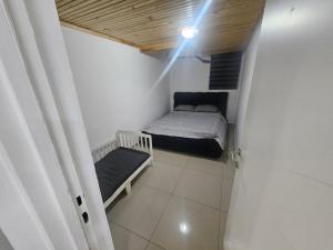 a small bedroom with a bed and a light at באוירה יהודית in H̱azon +9 photos