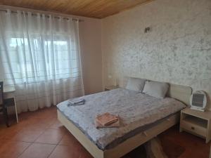 a bedroom with a bed with a towel on it at Gintolina in Kazlų Rūda
