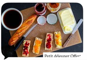 a table topped with different types of food and a cup of coffee at Maison gasconne in Castillon-Debats