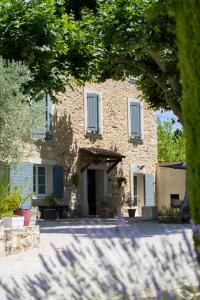 a large brick building with white shutters on it at Mas de la Bimarde in Monteux +38 photos